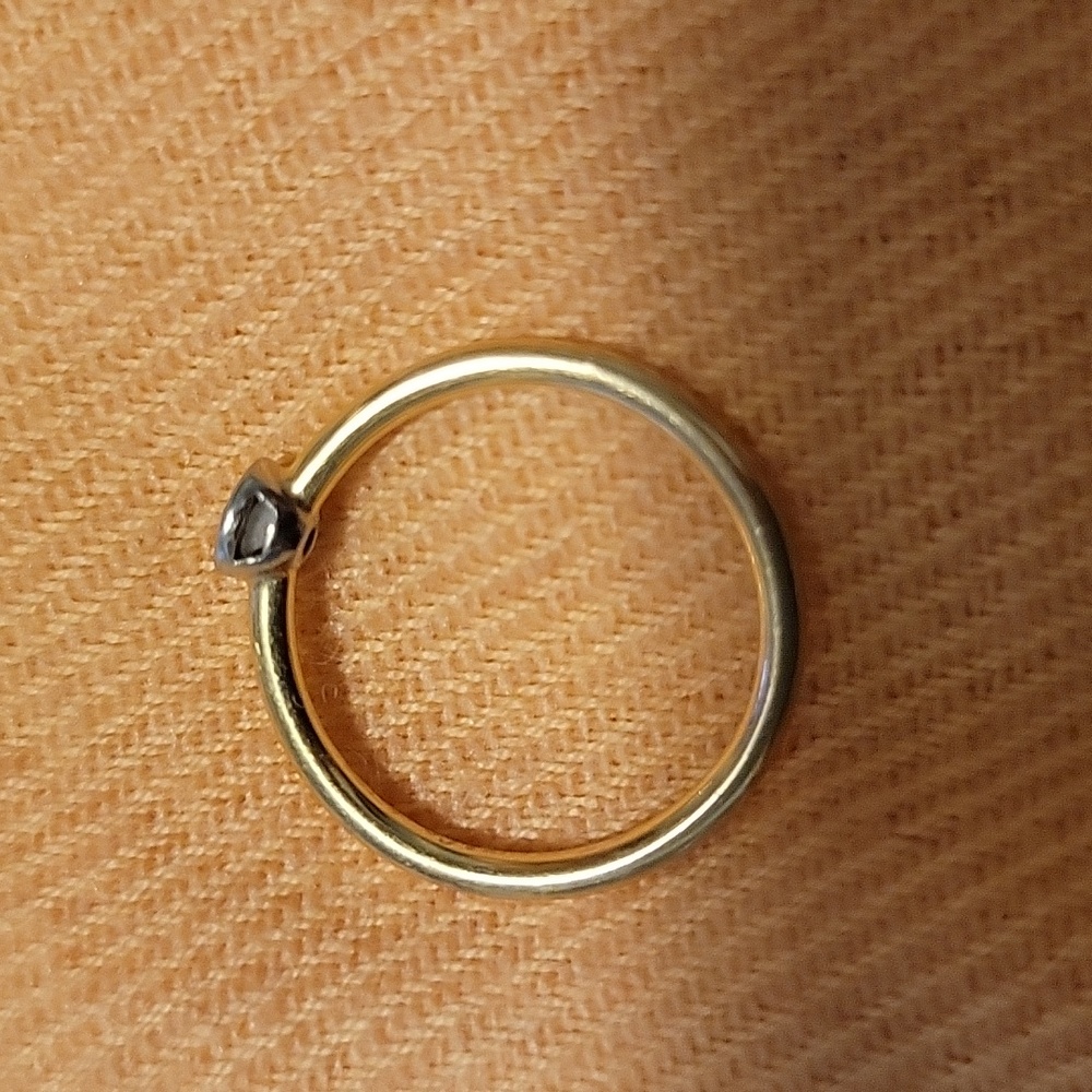 Tiffany & Co. 18K rose gold stackable diamond solitaire ring.